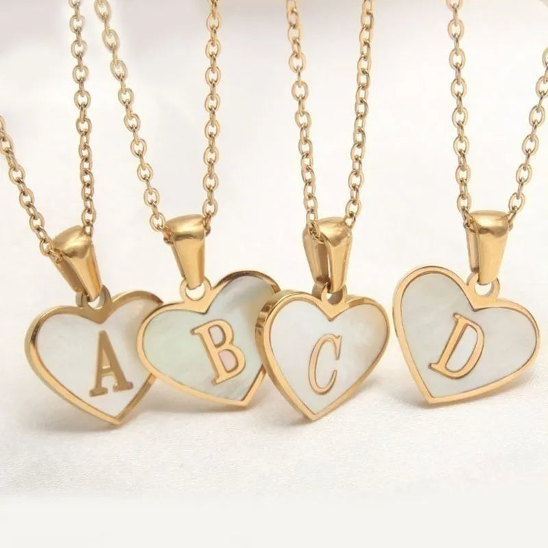 Gold plated initial necklace with white shell heart pendant and adjustable chain