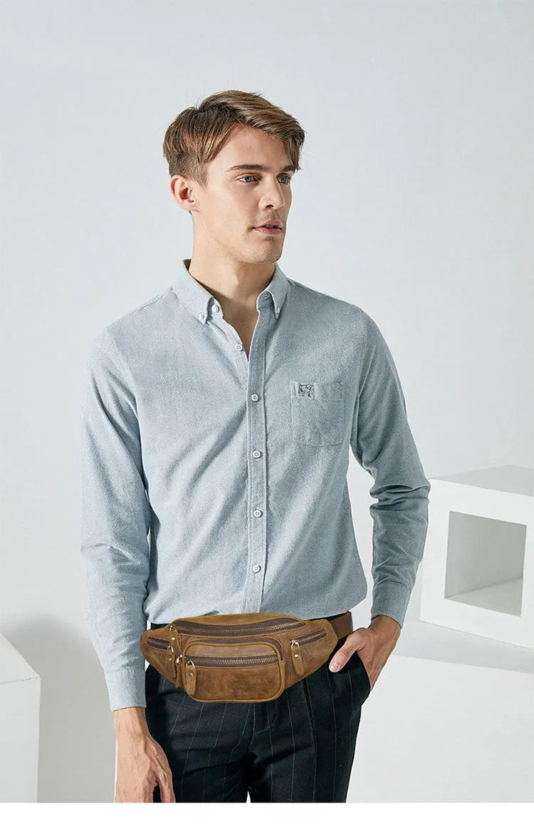 Brown cowhide leather messenger bag with a single shoulder strap, shown closed.