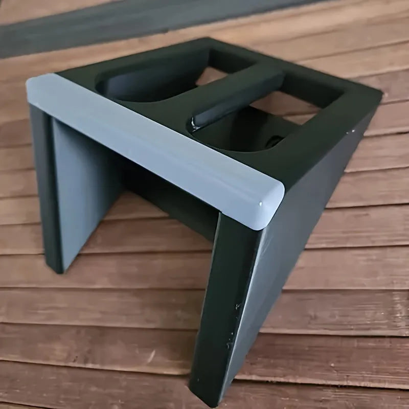 Black plastic pistol display stand for handguns and replicas on a flat surface.
