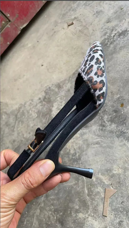 Leopard print suede women's sandals with a pointed toe and a heel.