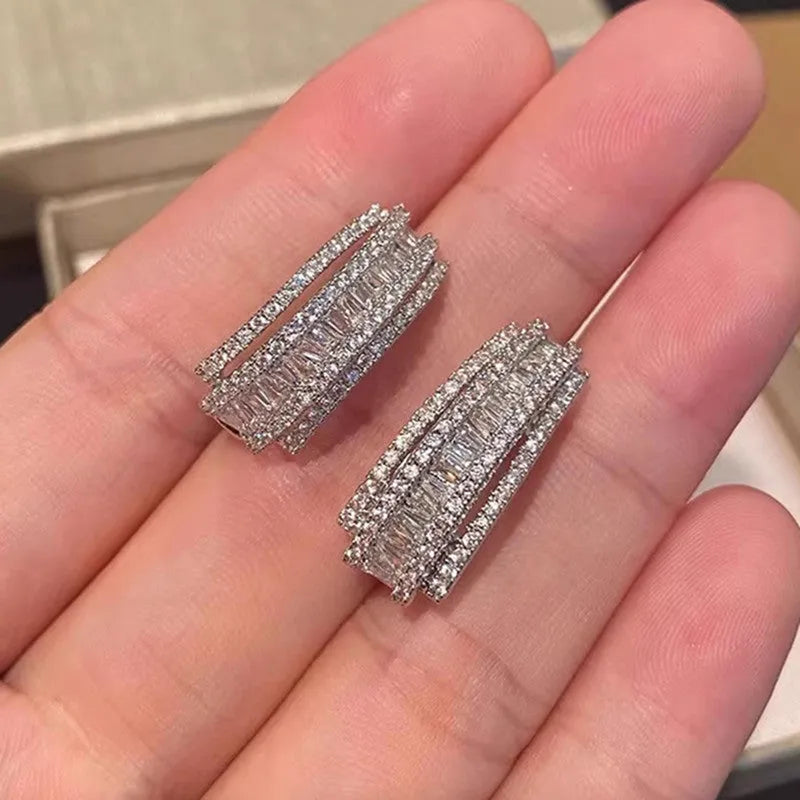 White gold coloured geometric stud earrings with zircon stone accents on copper metal for women