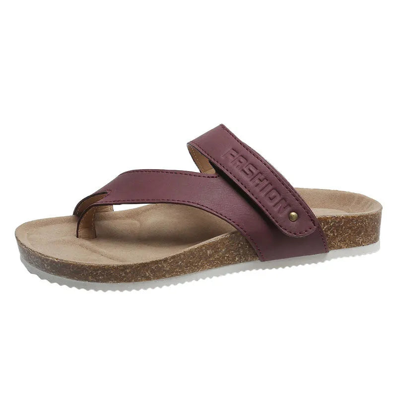 A pair of women's thick-soled flip-flops with a flat toe ring design in a solid colour.