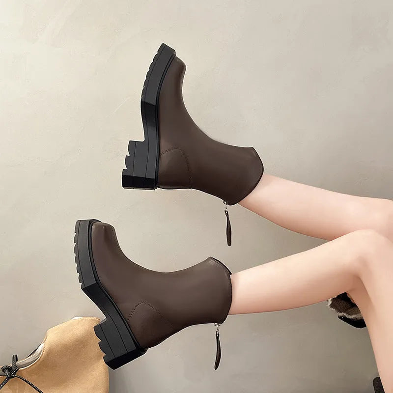 Black women's platform Martin boots with square toe, high heel, and back zip on a white background.