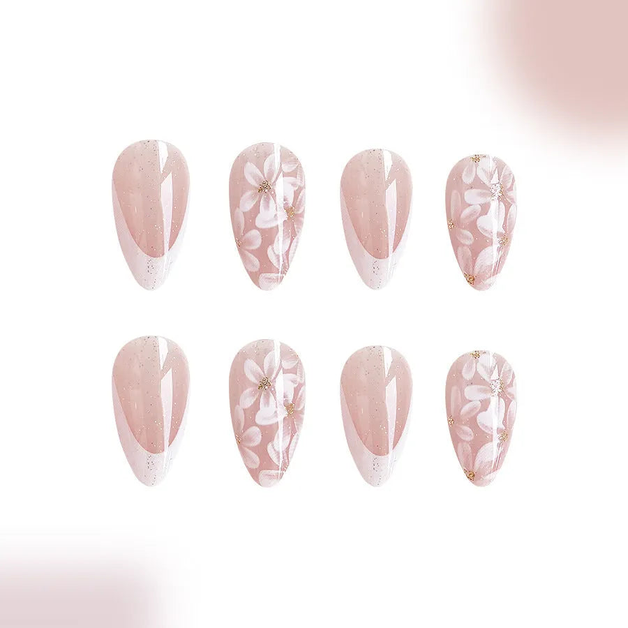 Short almond artificial nail tips with French manicure and glitter flower design in C625 colour