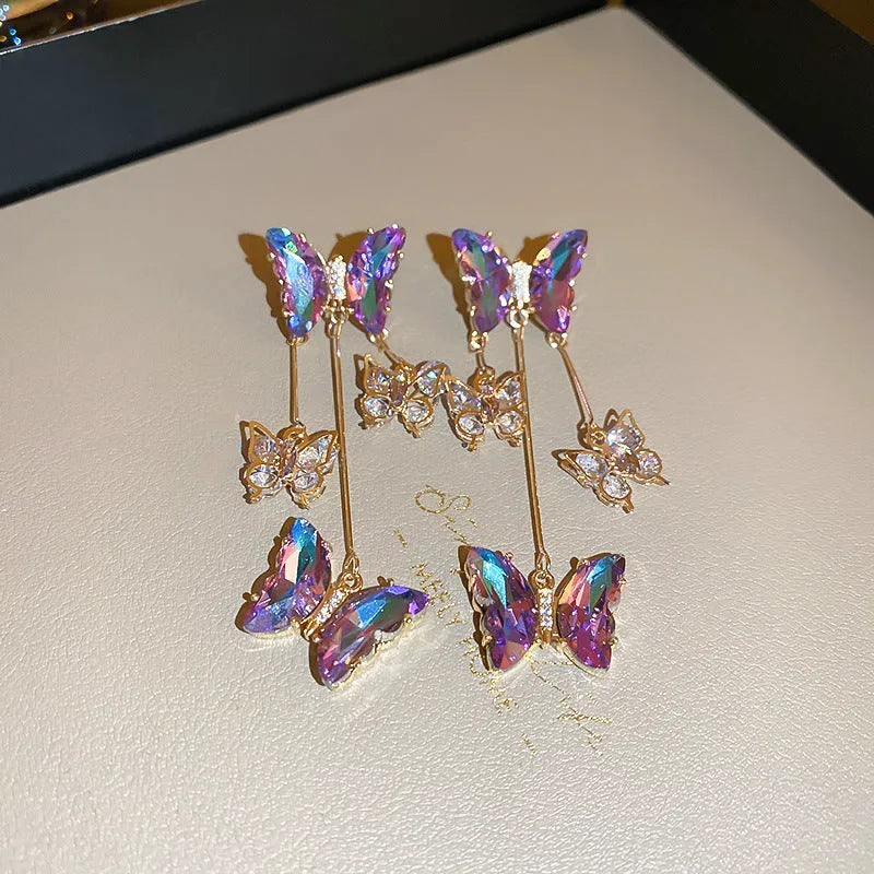 Silver needle crystal flowers butterfly tassel earrings in blue purple colour on alloy backing