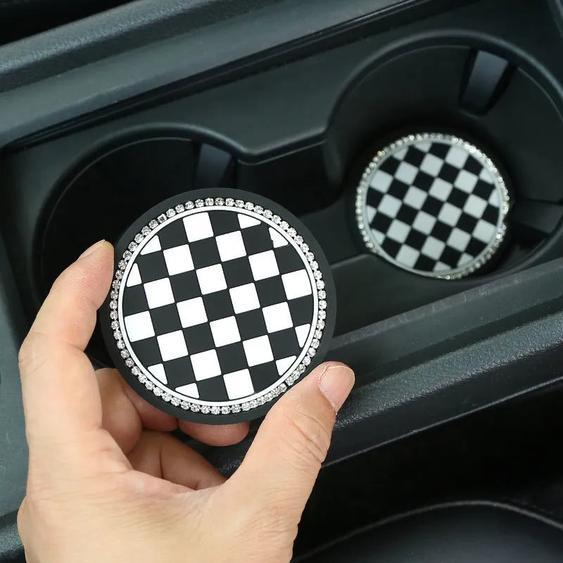 PVC car cup holder mat in black and white checkerboard pattern showing dimensions of 15.2 by 10.1 centimetres
