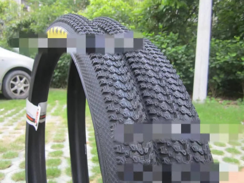Ultralight mountain bike tyre with reinforced sidewall shown in black, suitable for 26, 27.5 or 29 inch wheels