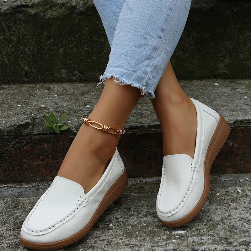 Women's PU leather flat loafers in multiple colours with round toe and car suture detail.