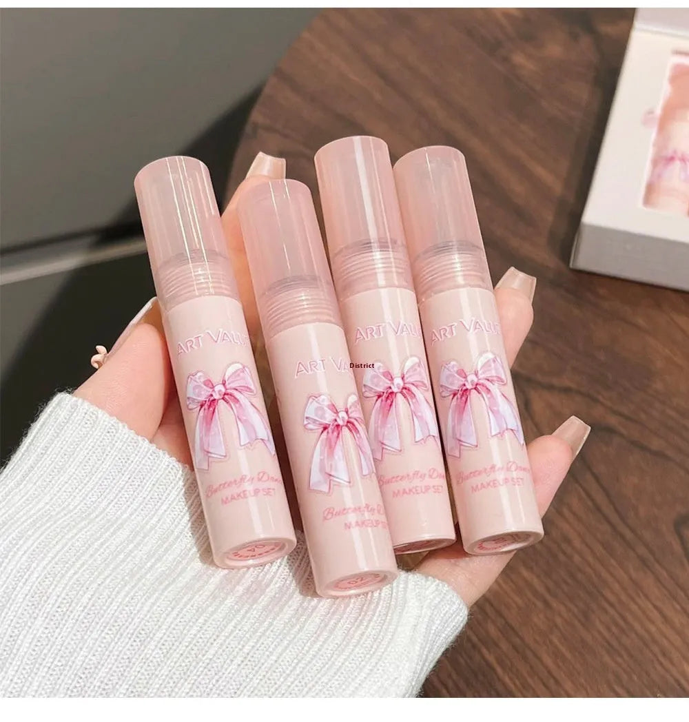 Butterfly Box makeup set showing four lip mud containers, powder blusher, and necklace in pink packaging