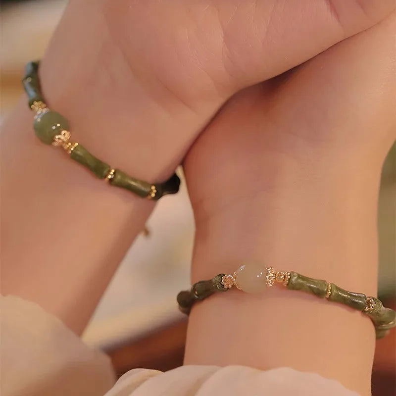 Dark green Hetian jade bracelet with geometric bamboo festival design on wrist