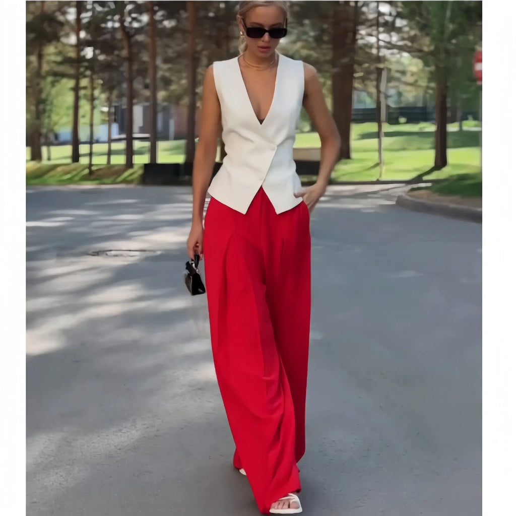Women's beige two-piece set with deep V-neck sleeveless top and high-waist wide-leg trousers.