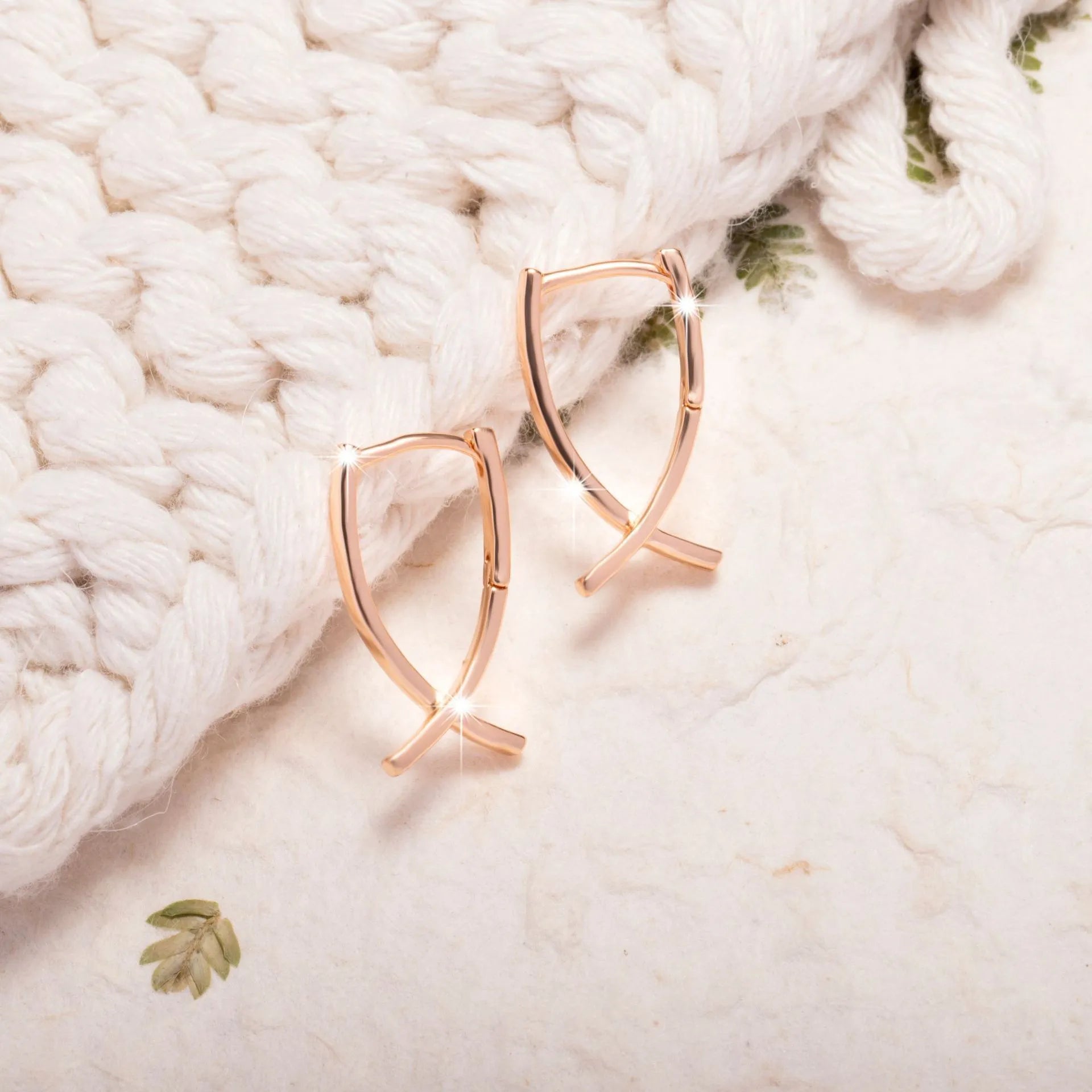 Rose gold cross shaped earrings made from copper with geometric design