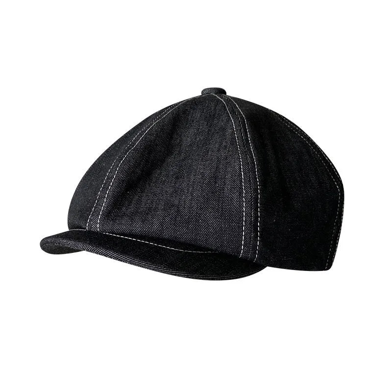 Black cotton retro-style beret for men and women on a plain background.