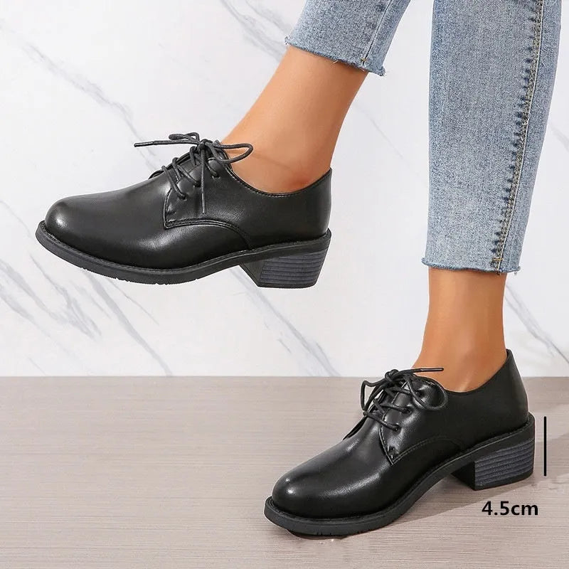 Black women's low-top work shoes with a chunky heel and pointed toe.