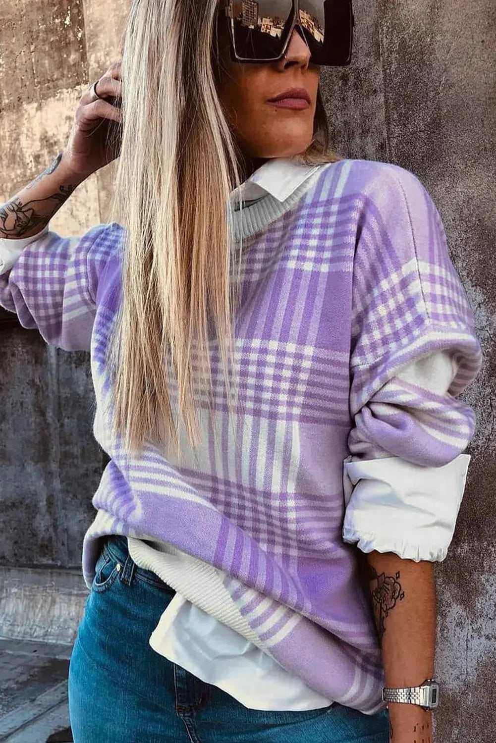 Lilac plaid print loose sweater with ribbed cuffs and collar on a hanger.
