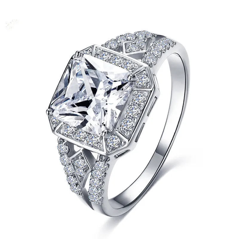 Geometric zircon ring with hollow design in platinum colour on copper, showing quadrilateral pattern and inlaid detailing