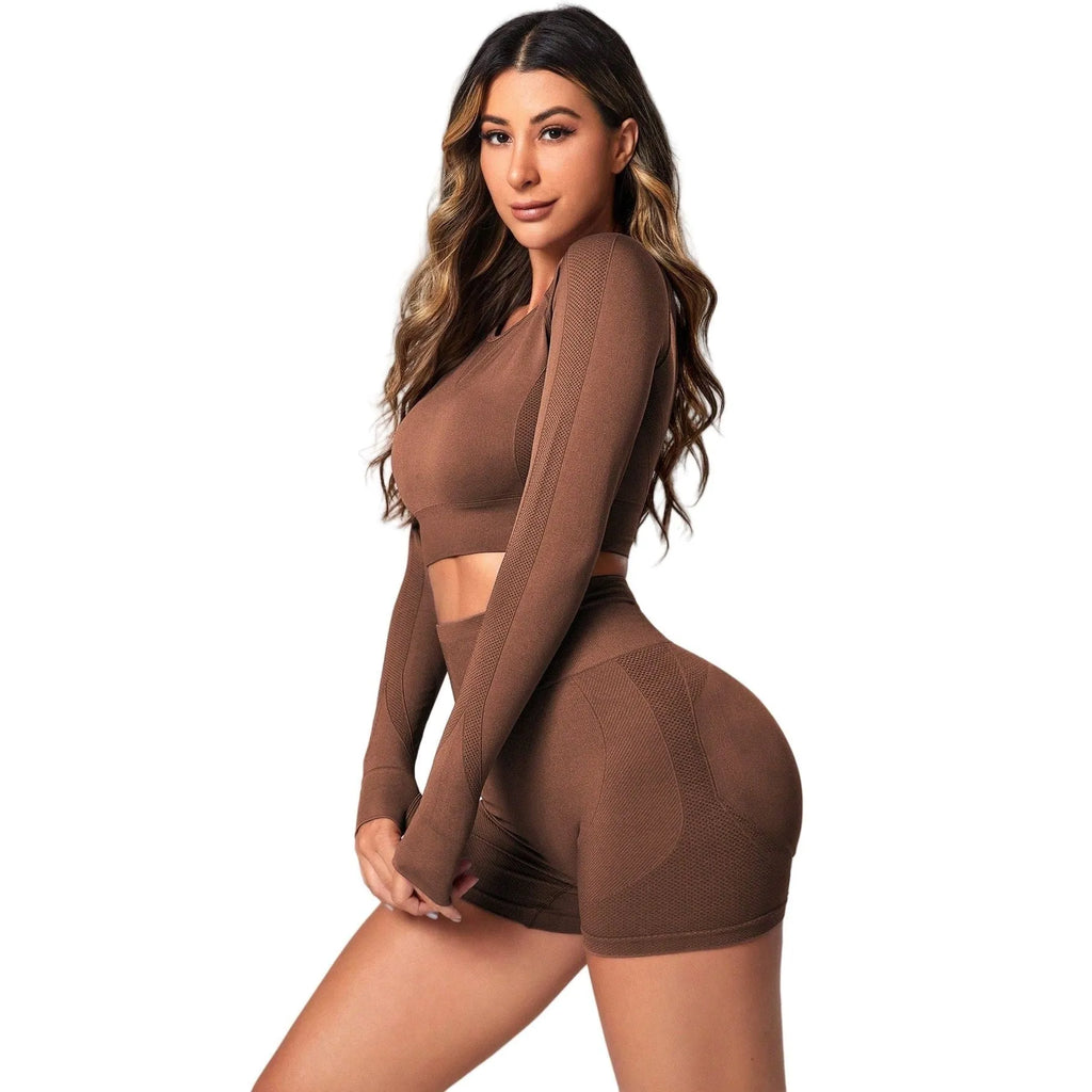 Women's black yoga suit set showing long sleeve pullover top and high-waisted tight-fitting pants.