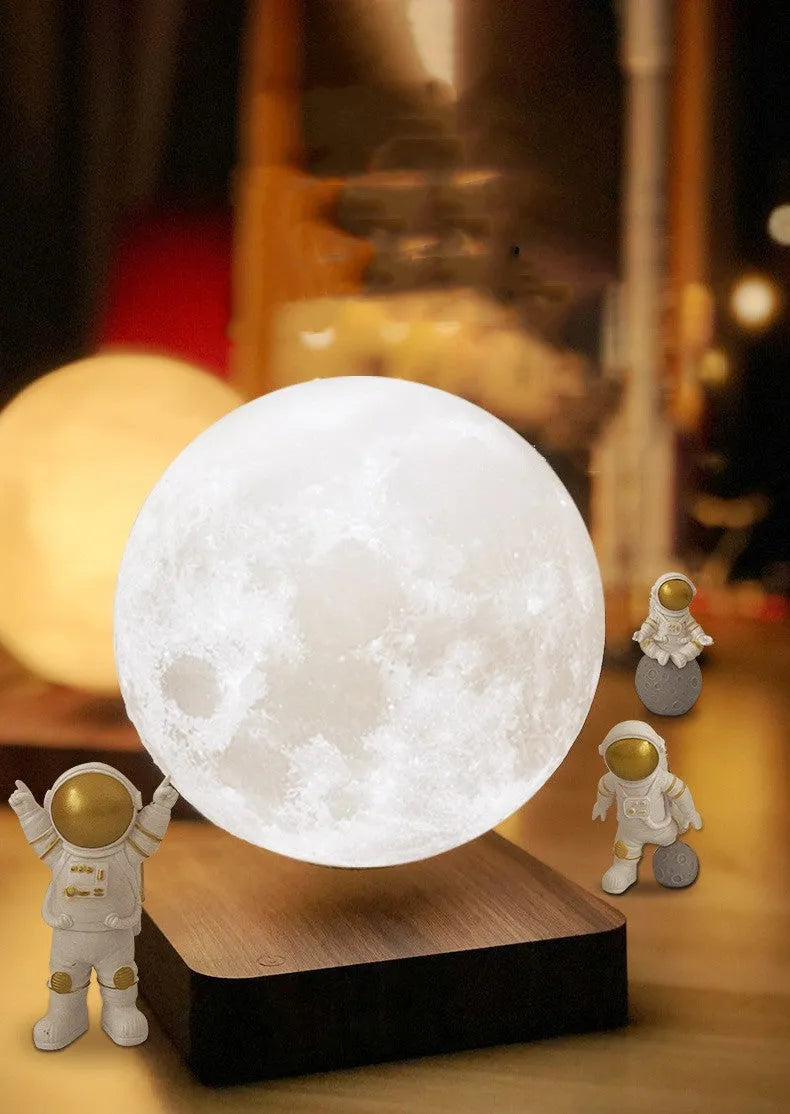 Maglev Moon Earth planet night light floating above base with LED glow, next to astronaut figurines.