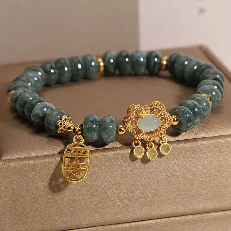 Natural emerald green jade abacus beads bracelet with a metallic alloy safety lock clasp.