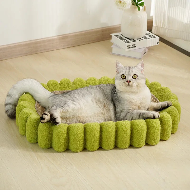 Green oval-shaped sisal cat scratching pad lounge bed on a floor.