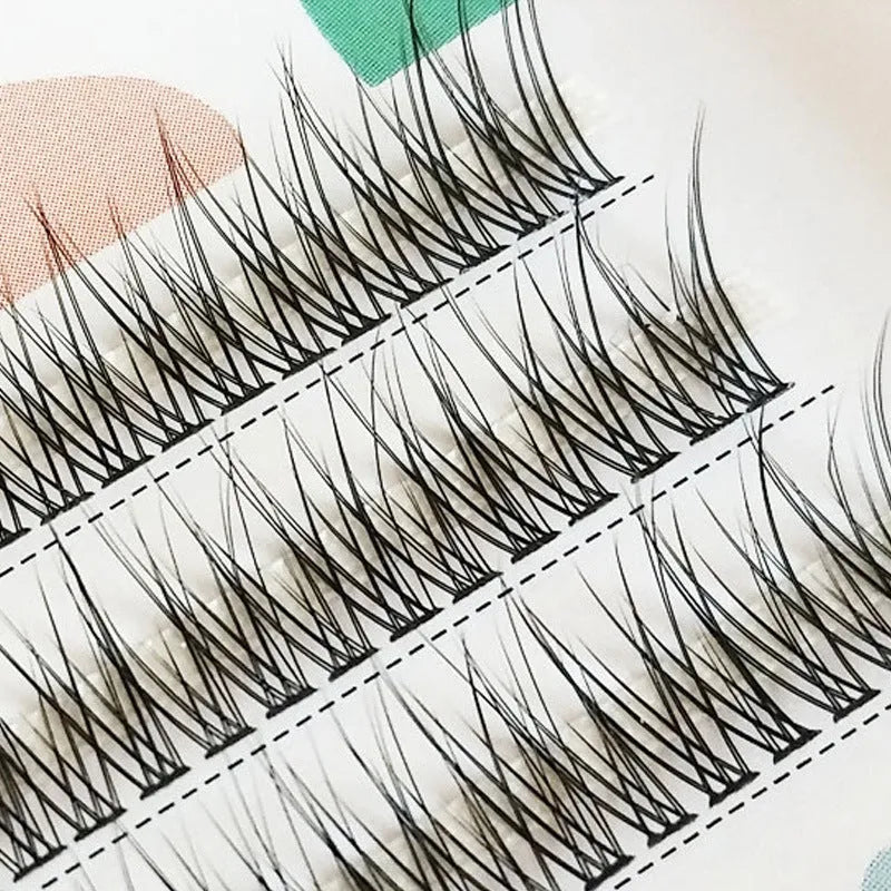 Black v-shaped fairy fishtail false eyelashes with thick segments on a clear band.