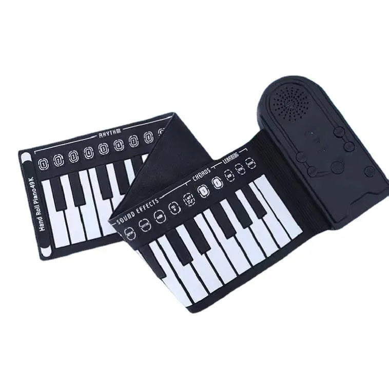 Portable black folding electronic keyboard rolled up next to its control panel and cable.