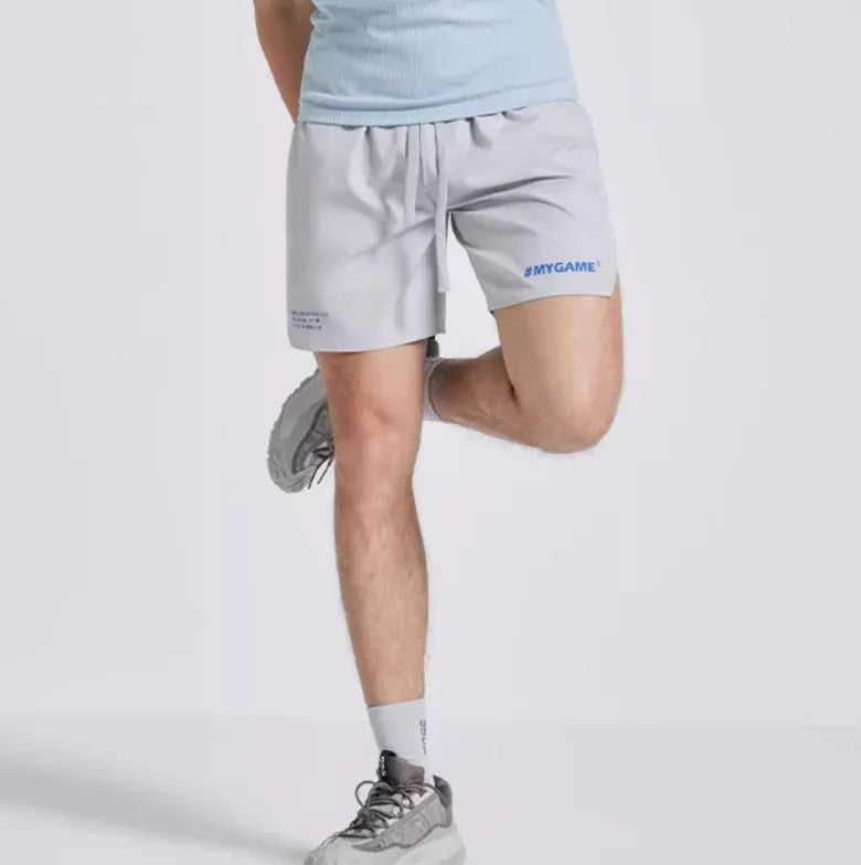 Men's blue training shorts with moisture-wicking fabric on a grey background.