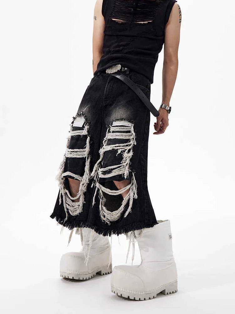 Black women's wide leg cropped jeans with ripped patch detail and a mid-high waist on a hanger.