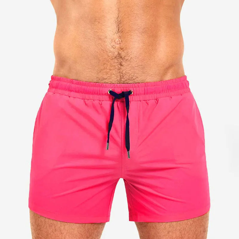 Solid colour swimming shorts with mesh lining for sports and fitness activities