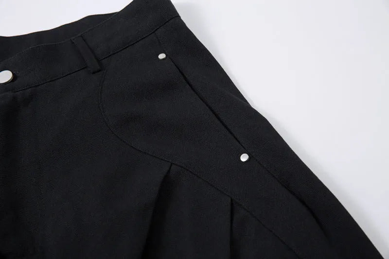 Men's black pleated casual trousers with a loose wide-leg fit and elasticated mid-waist.