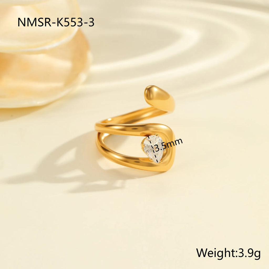 Geometric stainless steel open mouth ring with zircon detail and electroplated finish.