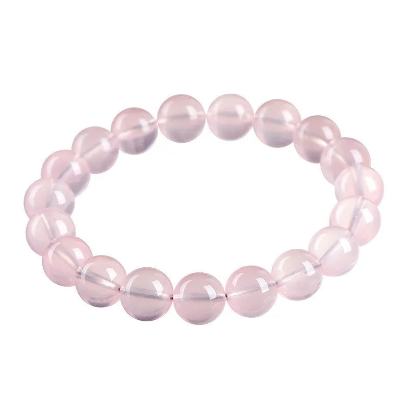 Natural starlight crystal round beads bracelet for women in pink, showing polished beads on a wrist.