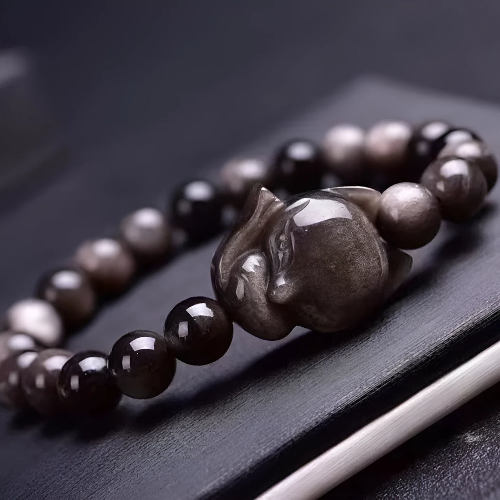 Black obsidian bracelet with fox design featuring 8mm polished stones and adjustable closure