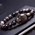 Black obsidian bracelet with fox design featuring 8mm polished stones and adjustable closure