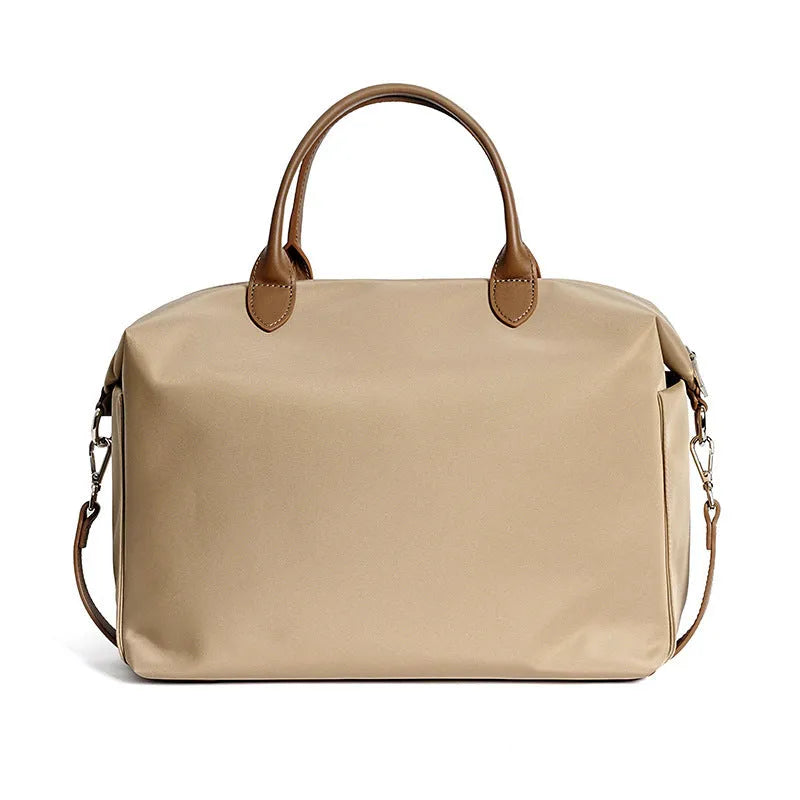 Black large capacity nylon waterproof shoulder bag with leather accents on a plain background.