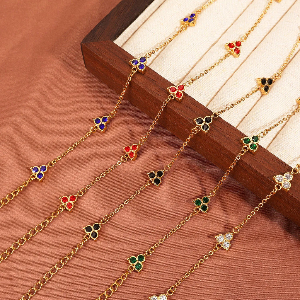 Geometric triangle bracelet for women in stainless steel with coloured zircon stones.