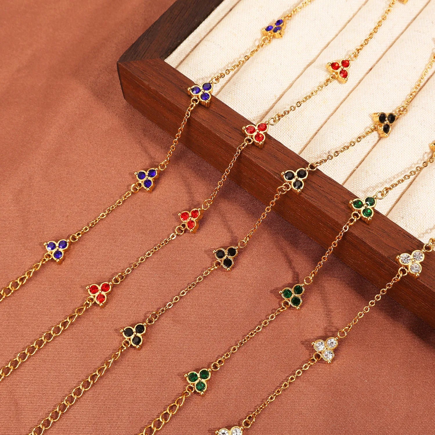 Geometric triangle bracelet for women in stainless steel with coloured zircon stones.