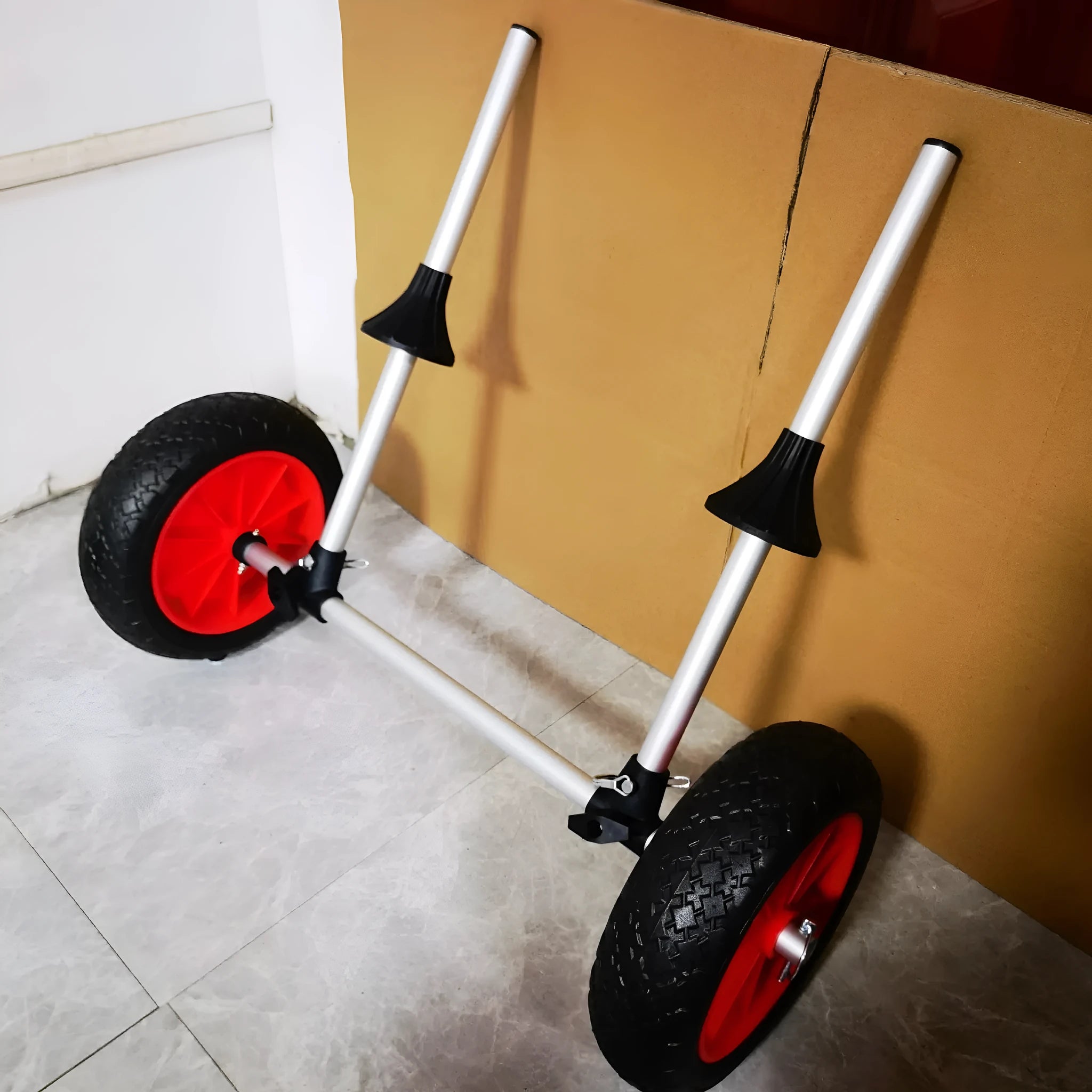 Foldable aluminium kayak cart with wheels and platform for transporting open kayaks.