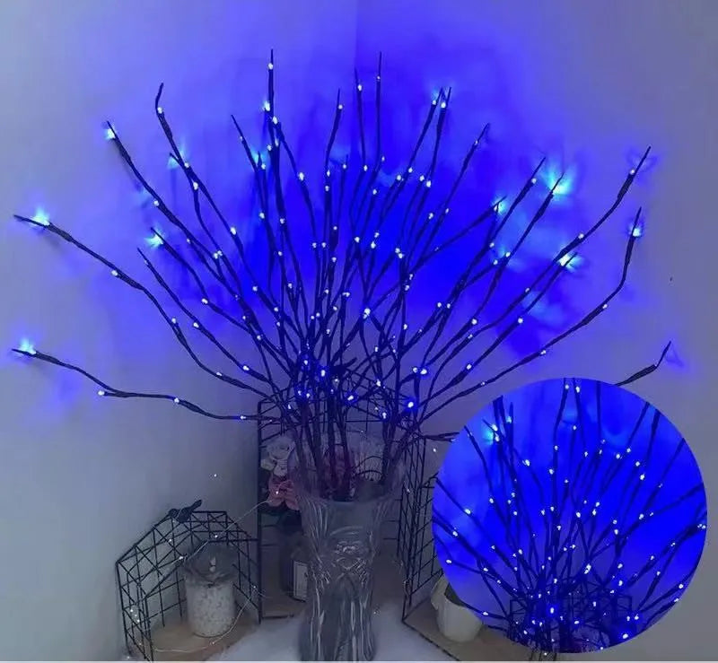 LED decorative tree light with silver branches in a vase, emitting coloured light.