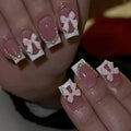 Short white French manicure press-on nails with bow designs and multiple patterns