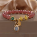 Red women's bracelet with strawberry quartz beads, alloy settings, and sparkling rhinestone details.