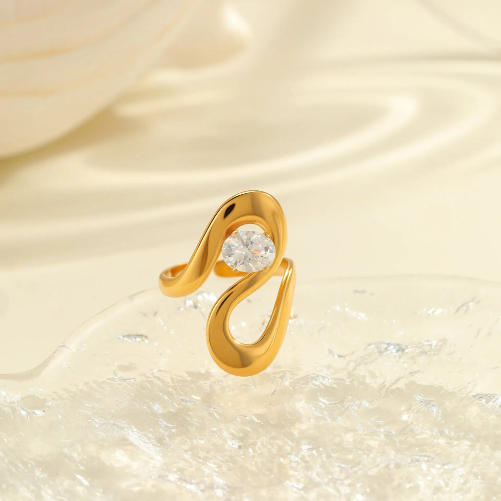 Geometric stainless steel open mouth ring with zircon detail and electroplated finish.