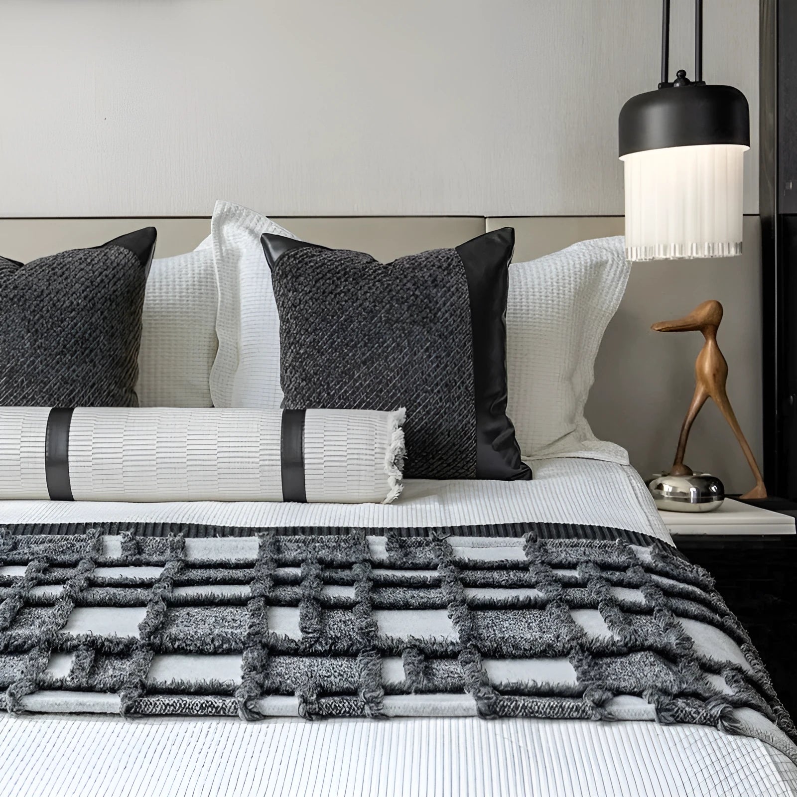 Modern minimalist grey and white plaid bed runner blanket with matching pillowcase and round leather pillow