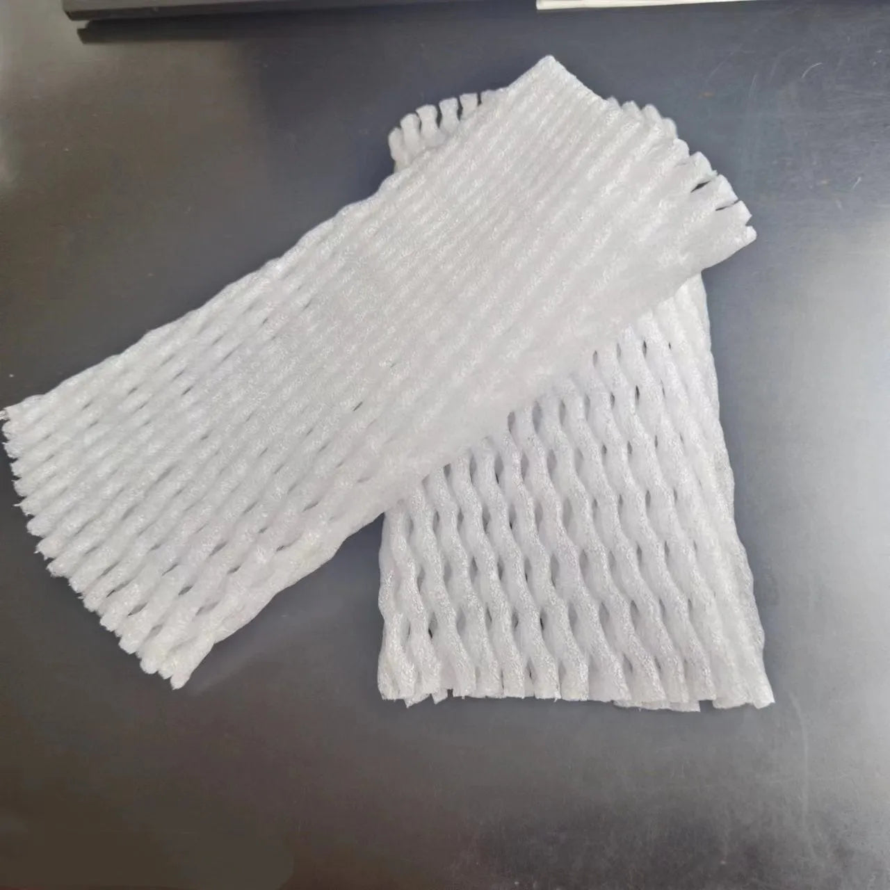 White foam net covers for fruit protection in multiple sizes on various fruits