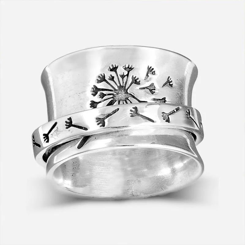 Silver coloured rotating flower fashion ring on a hand, showing adjustable band and floral design.