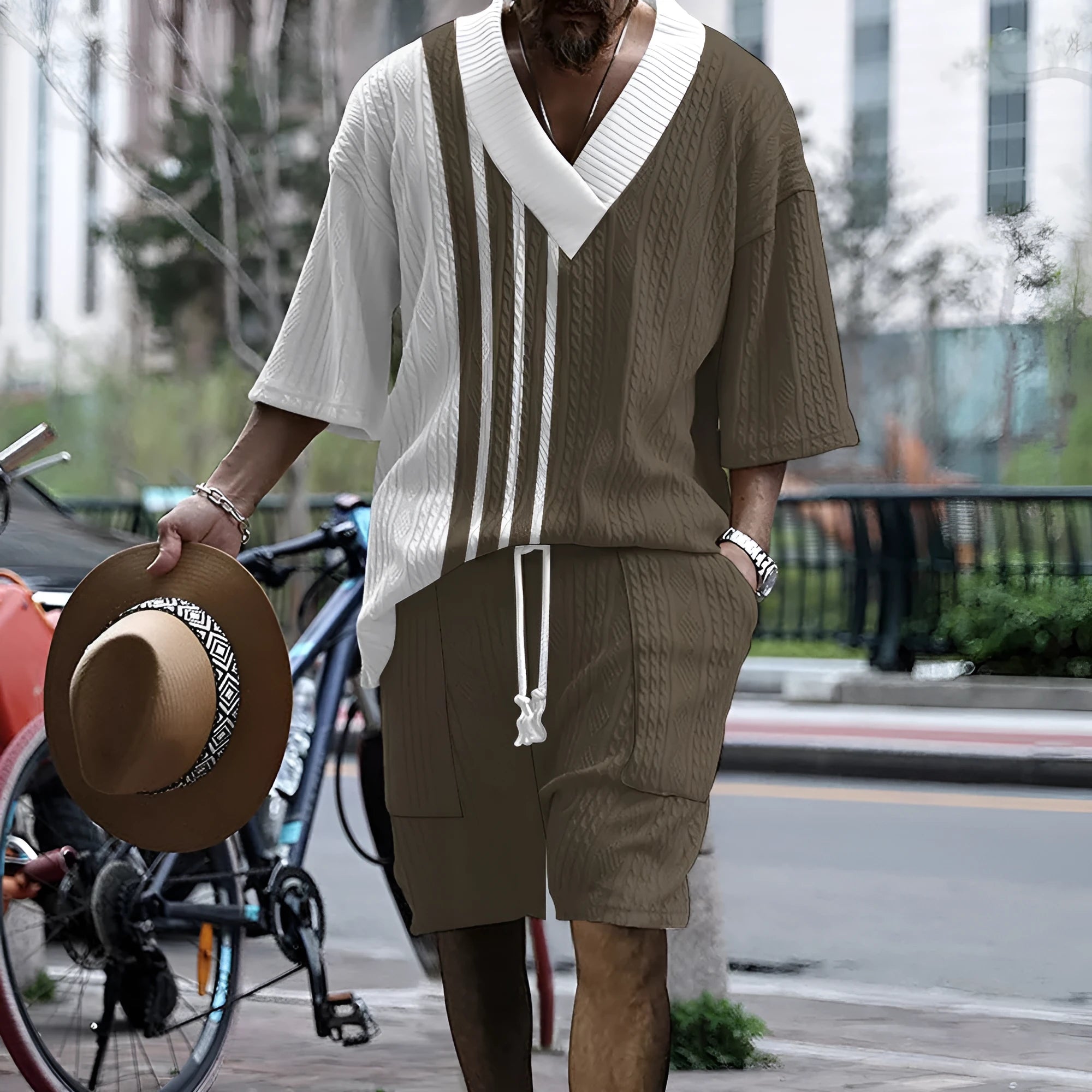 Men's grey printed knitted shorts suit with drop-shoulder short-sleeved top on a hanger.