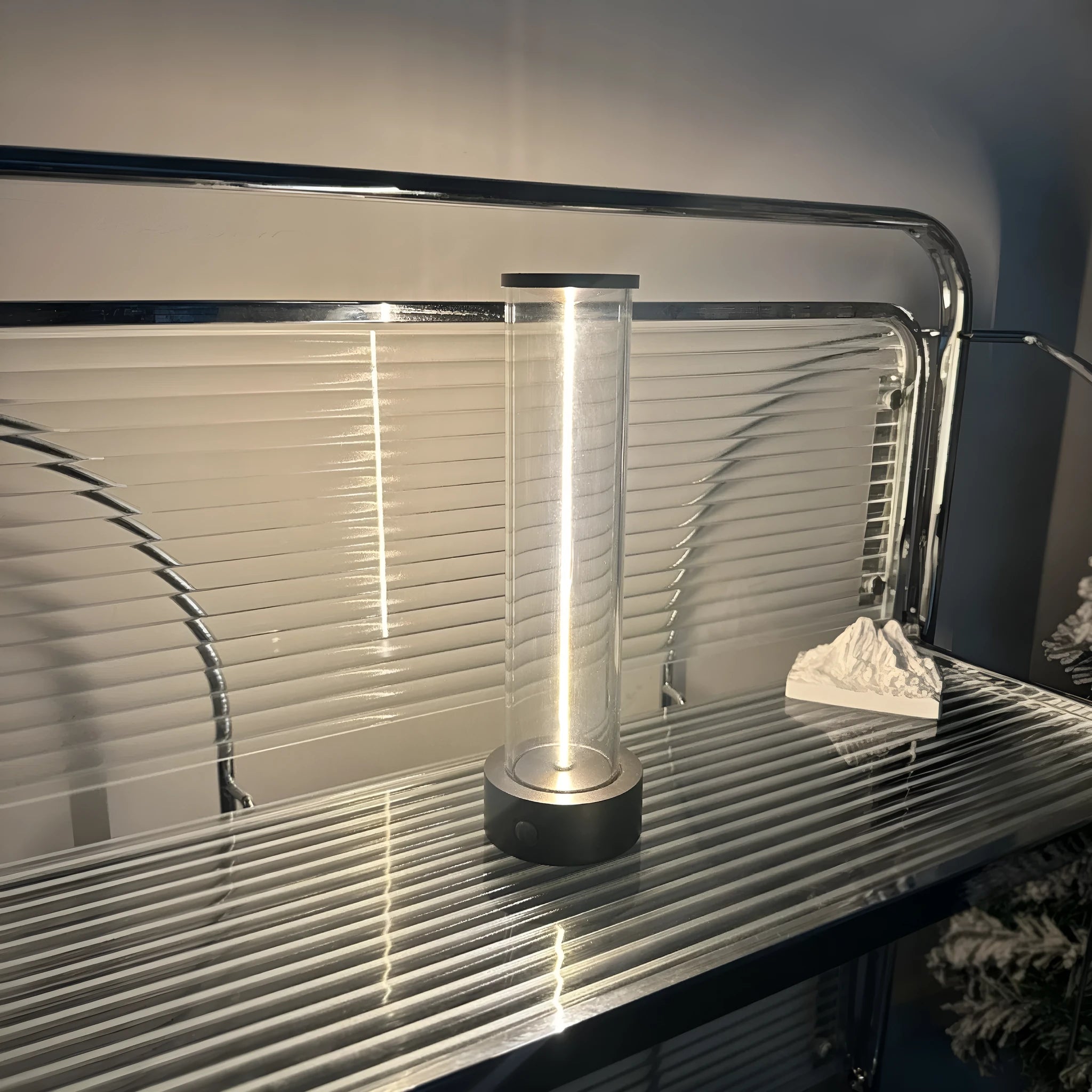Modern rectangular LED light strip with frosted glass panel, shown with USB cable for charging.
