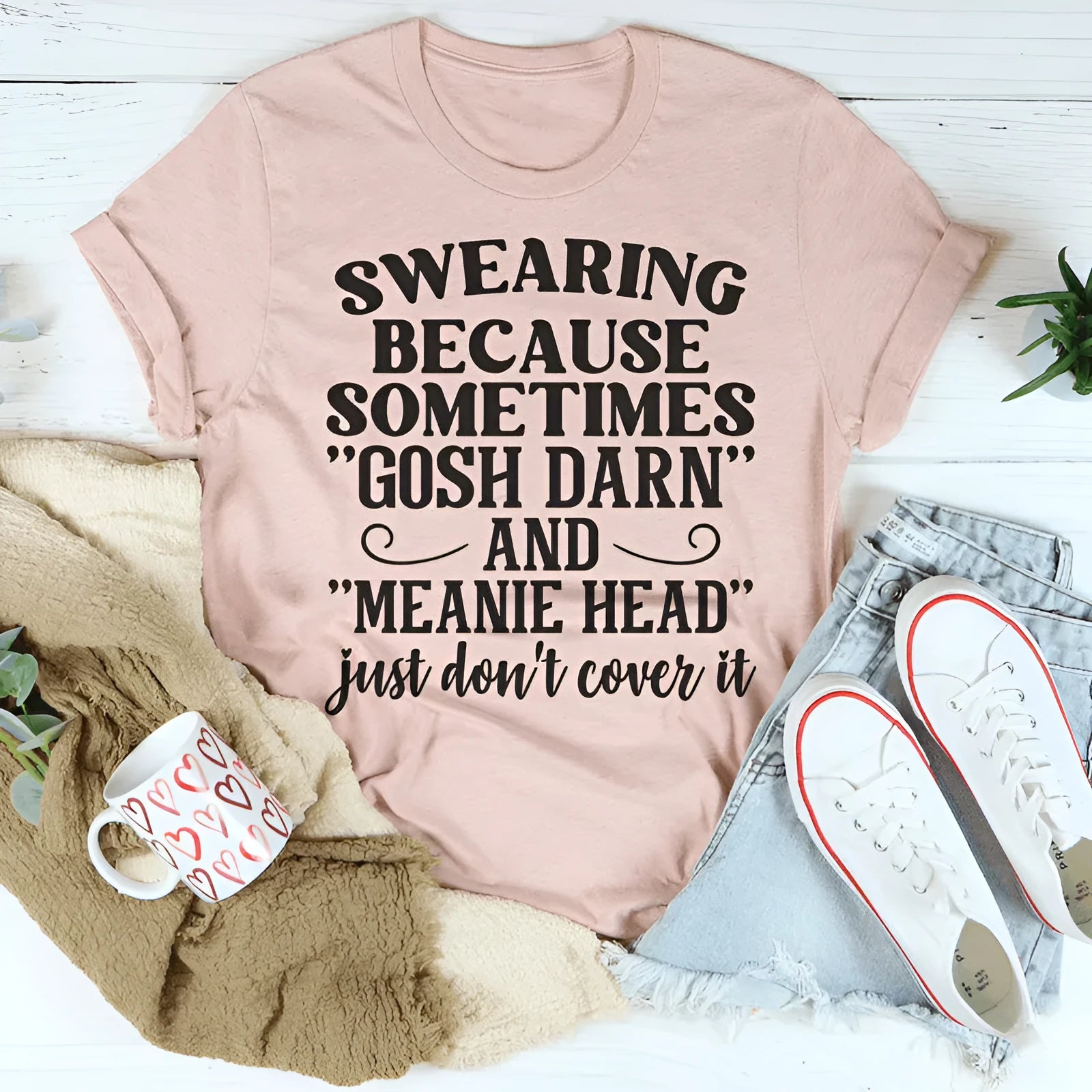 Pink unisex short-sleeve t-shirt with a printed design on a solid colour background, laid flat.