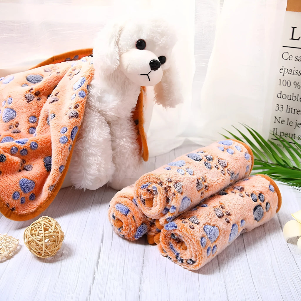 Coral fleece dog blanket showing dog's paw pattern in available colours with size options from XXS to XXL