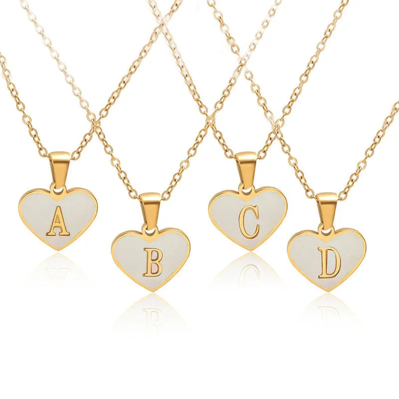 Gold plated initial necklace with white shell heart pendant and adjustable chain